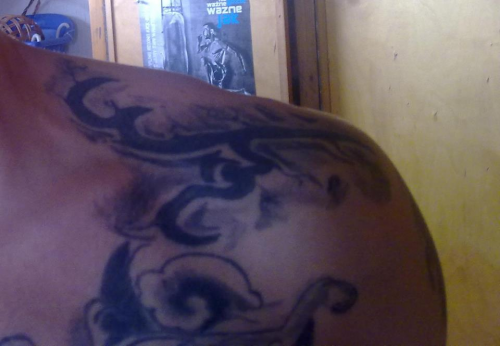 Adi Warded Shoulder Tattoo