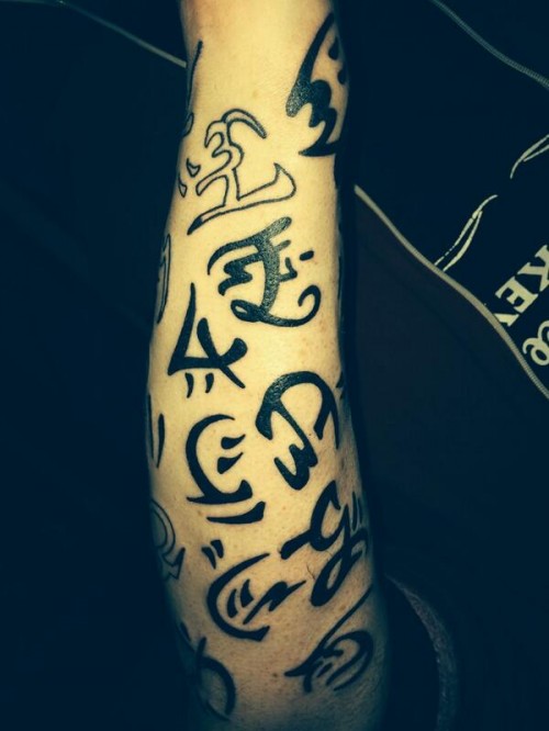 Andry warded arm tattoo