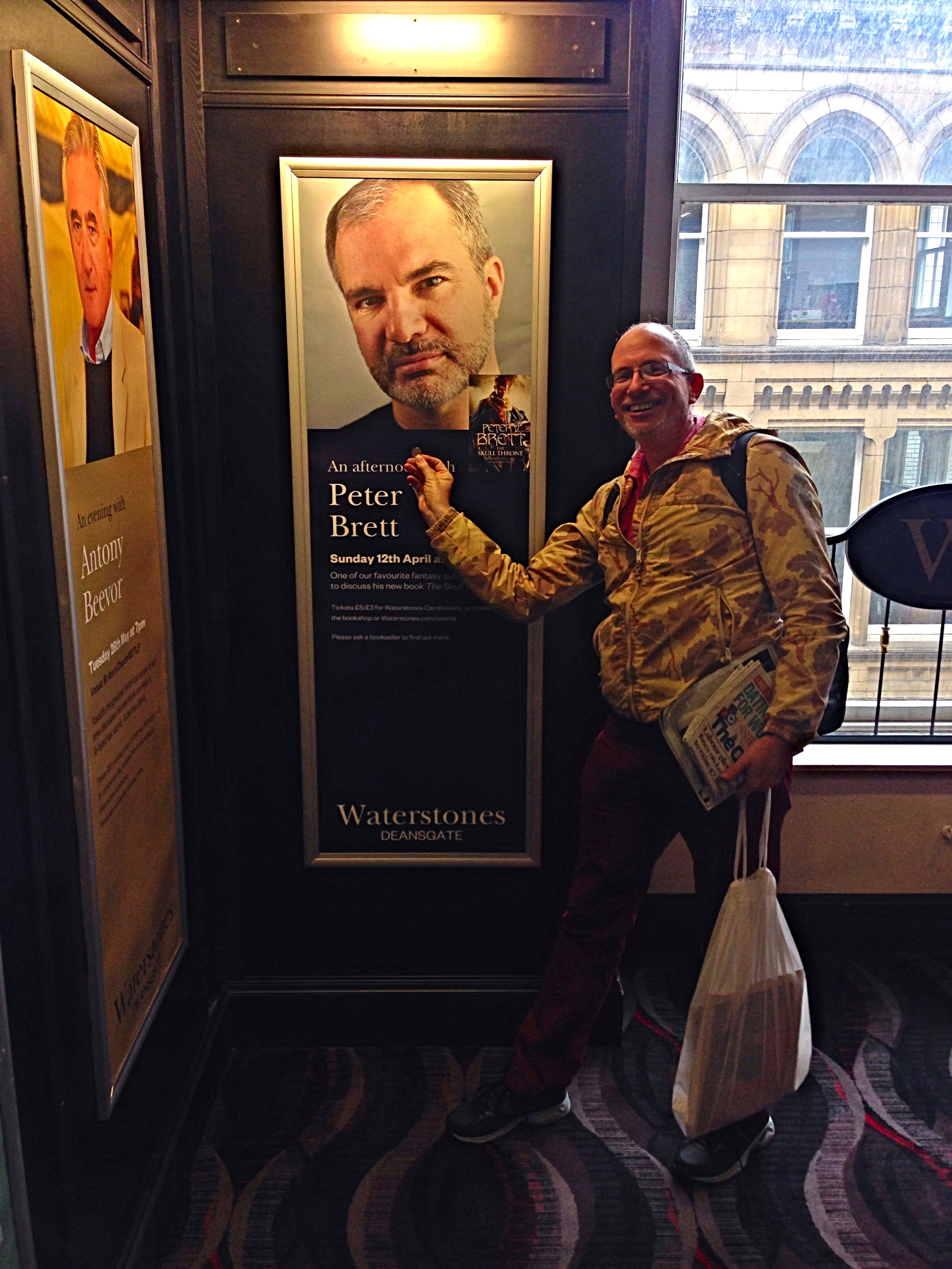 Joshua holds up pound for scale of poster