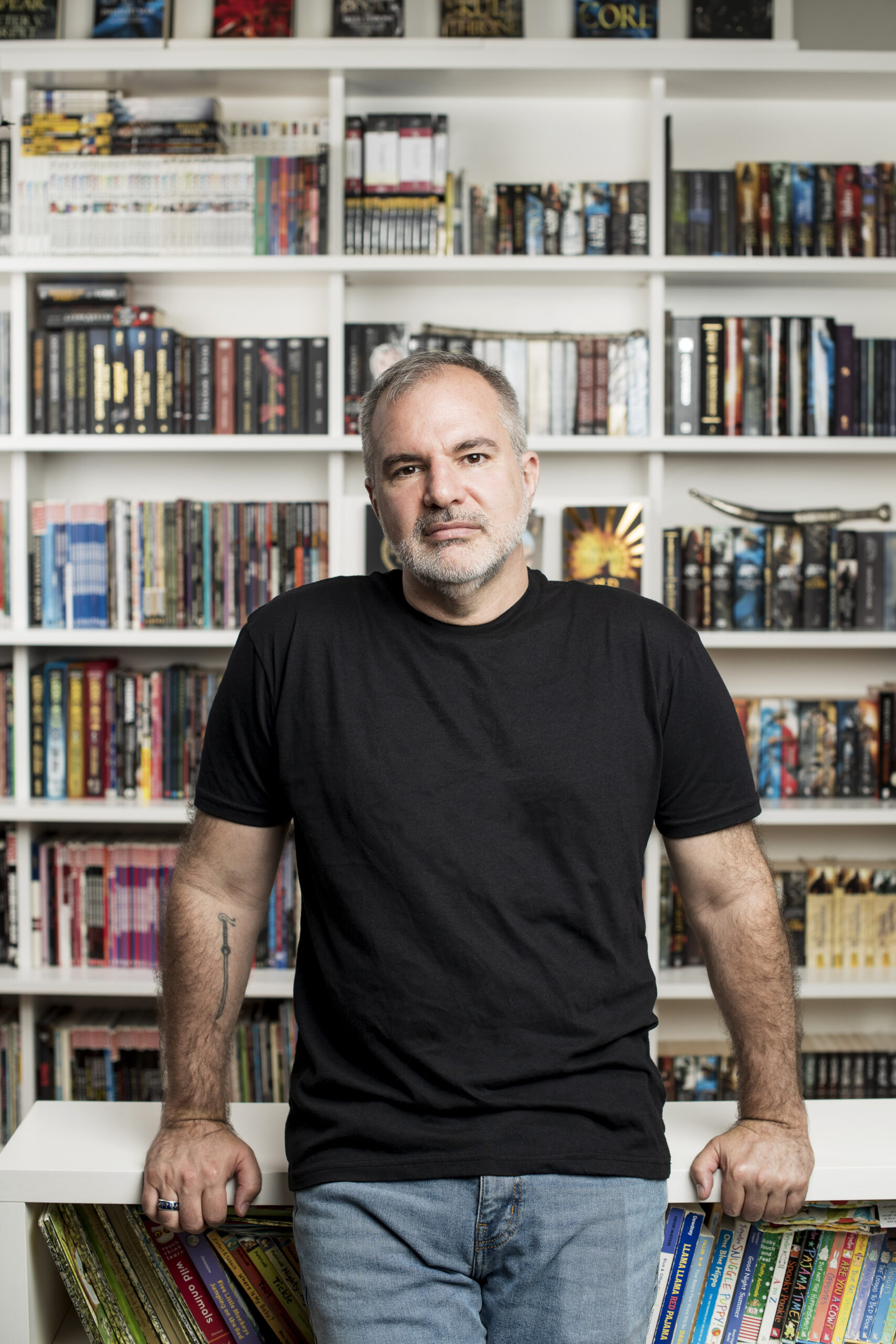 Peter V. Brett portrait with books, color